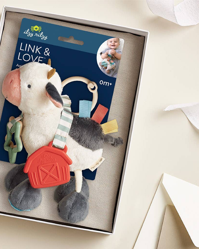 Peluche d’activités sensorielle bébé – Vache Itzy Friends Link & Love™ - Jouets d'éveil - Boutique LeoLudo - Itzy Ritzy Canada